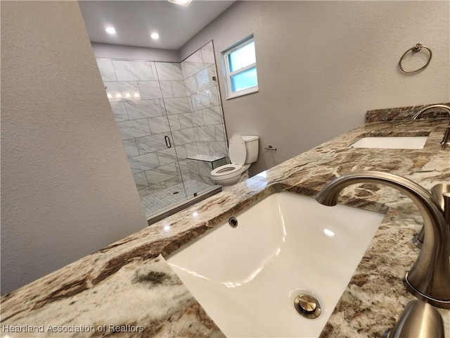 203 Boyer St, Venus, FL 33960 - bathroom with toilet, a stall shower, a sink, and a textured wall