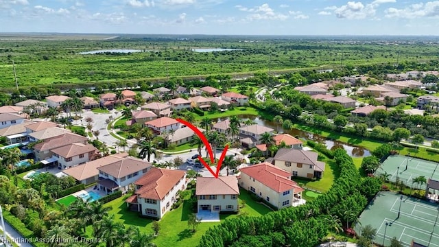 birds eye view of property with a water view