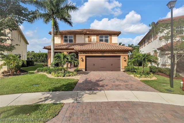 mediterranean / spanish-style house with a garage and a front lawn