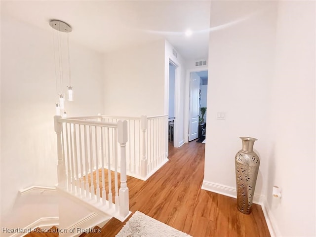 hallway with hardwood / wood-style floors