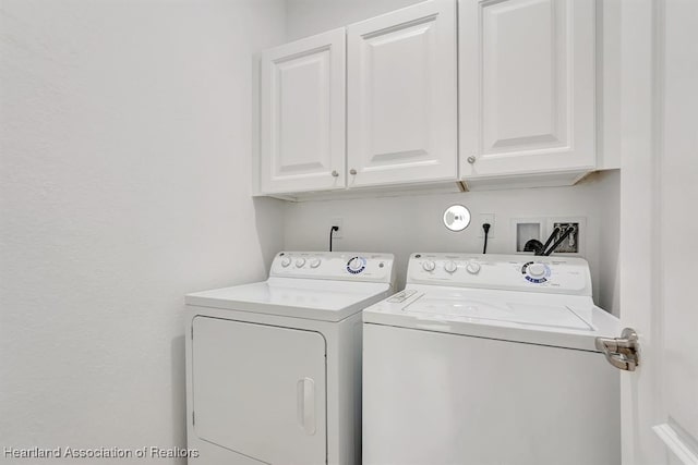 laundry area featuring cabinets and washer and clothes dryer