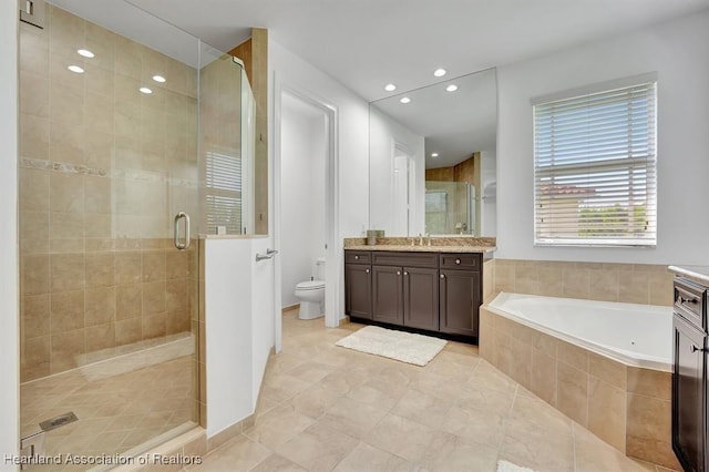 full bathroom featuring tile patterned flooring, vanity, toilet, and independent shower and bath