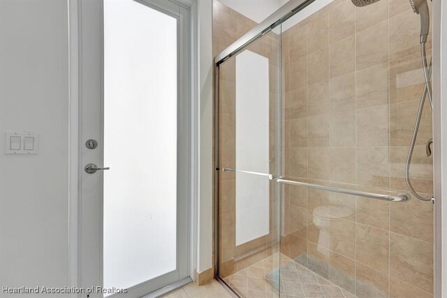 bathroom featuring a shower with door