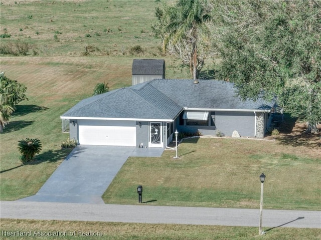 ranch-style home featuring a garage and a front lawn