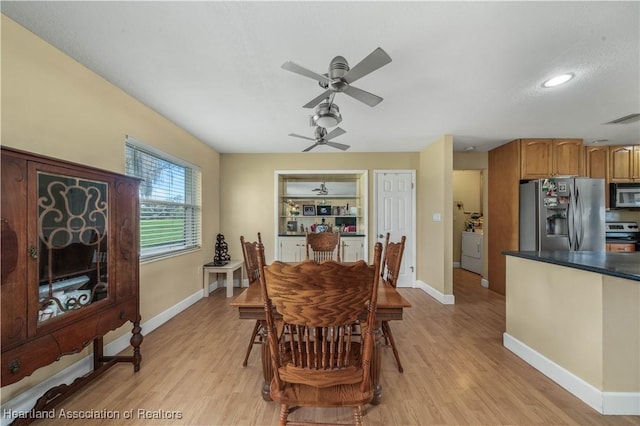 dining area with light wood-style flooring, visible vents, and baseboards