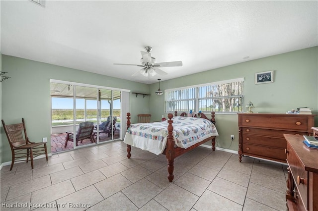 bedroom with light tile patterned floors, access to outside, multiple windows, and baseboards