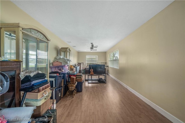 office area featuring wood finished floors, a ceiling fan, and baseboards