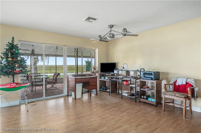 office area with ceiling fan, a textured ceiling, wood finished floors, and visible vents