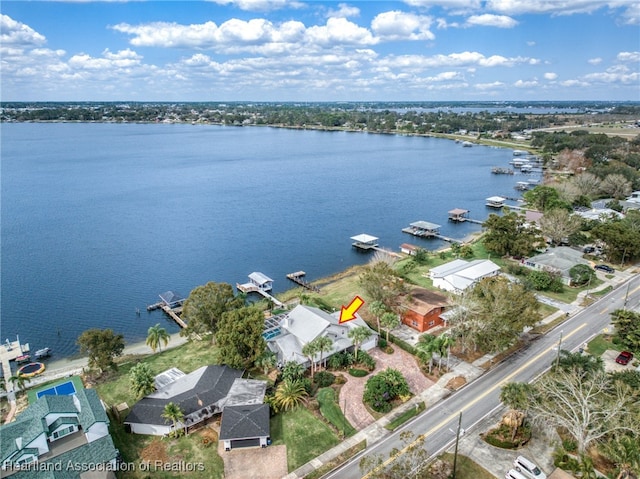 birds eye view of property with a water view