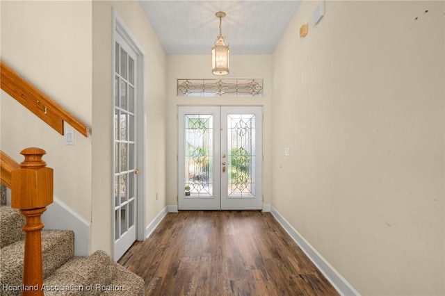 foyer entrance with french doors and dark wood-type flooring