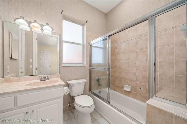 full bathroom with toilet, shower / bath combination with glass door, tile patterned floors, and vanity