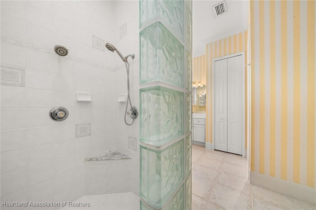 bathroom with a tile shower