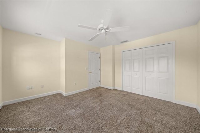 unfurnished bedroom with carpet, a closet, and ceiling fan