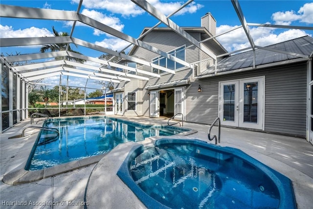 view of swimming pool featuring a lanai, an in ground hot tub, a patio area, and french doors