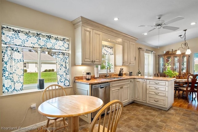 kitchen with pendant lighting, stainless steel dishwasher, sink, and a wealth of natural light