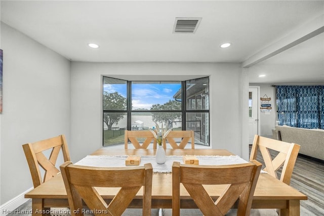 dining space with hardwood / wood-style floors