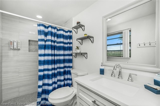 bathroom featuring vanity, a shower with shower curtain, and toilet