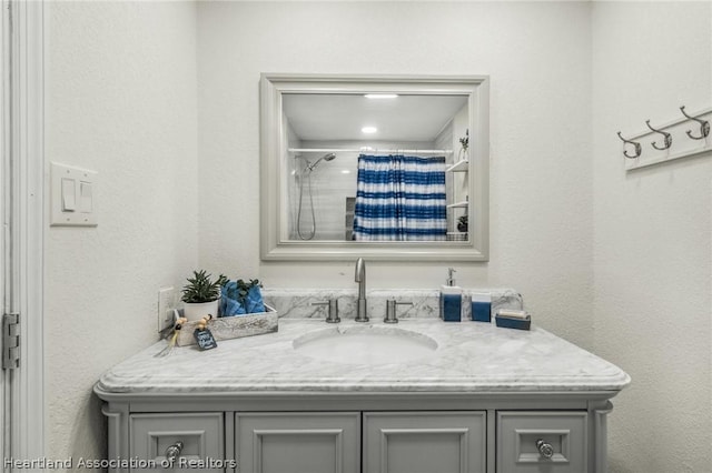 bathroom with vanity and curtained shower