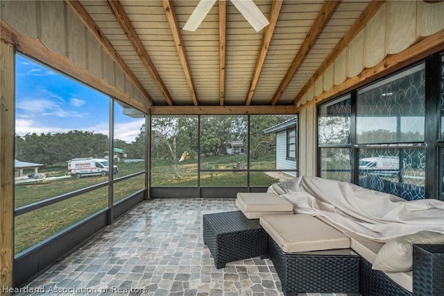 sunroom with vaulted ceiling with beams