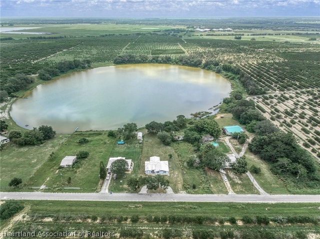 birds eye view of property featuring a water view and a rural view