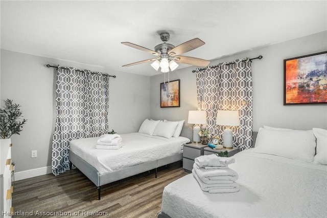 bedroom featuring dark hardwood / wood-style flooring and ceiling fan