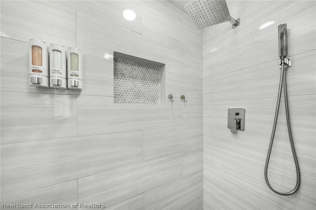 bathroom with a tile shower