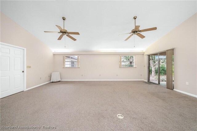 carpeted spare room featuring ceiling fan and high vaulted ceiling