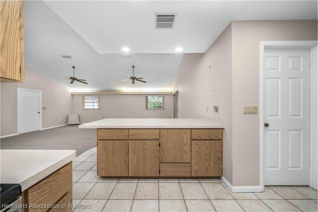 kitchen featuring light carpet, kitchen peninsula, ceiling fan, and stainless steel range with electric stovetop