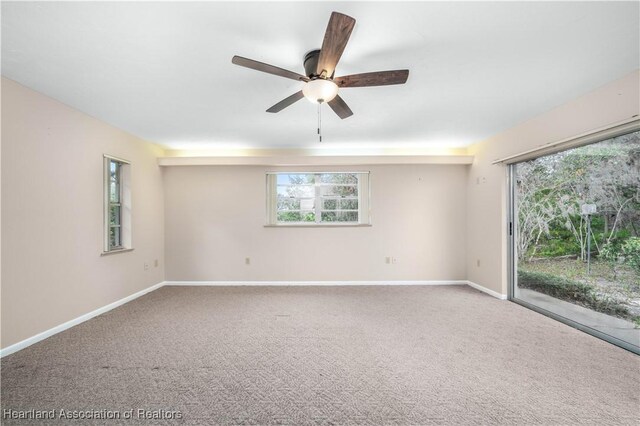 carpeted spare room with ceiling fan