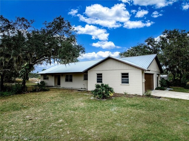 view of property exterior with a lawn and a garage