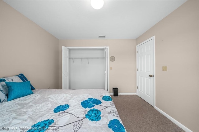 bedroom featuring dark carpet and a closet