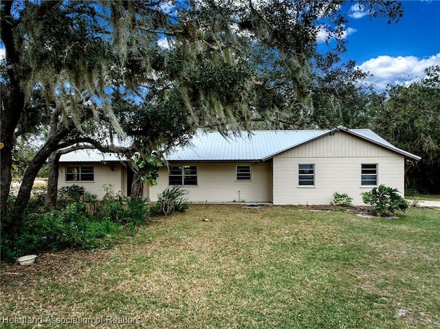 rear view of house featuring a yard