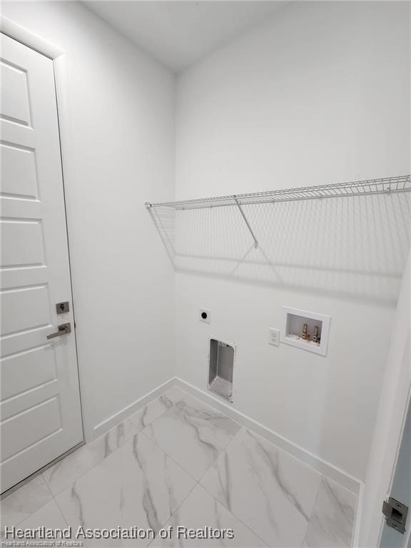 4983 San Lorenzo Dr, Sebring, FL 33872 - washroom with hookup for an electric dryer, baseboards, marble finish floor, laundry area, and washer hookup