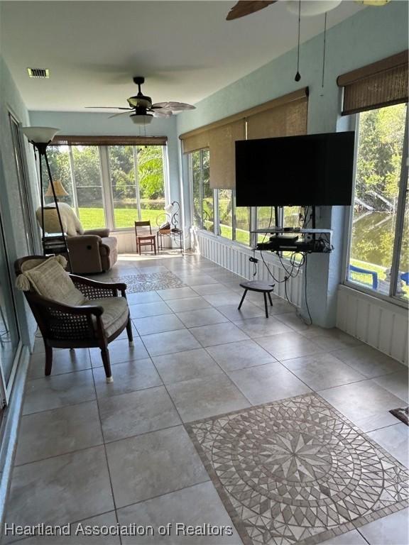 sunroom featuring ceiling fan and visible vents