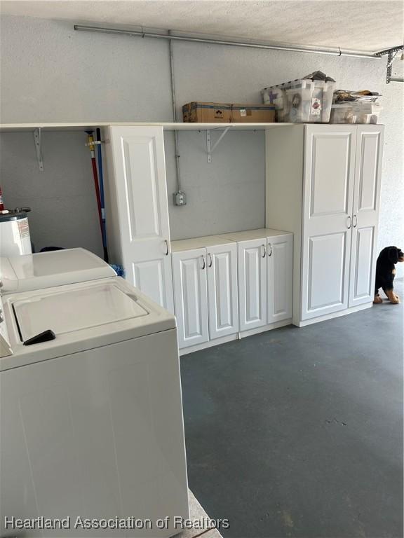 clothes washing area with washing machine and dryer