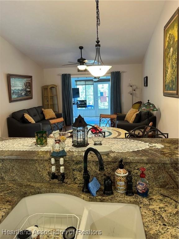 interior space with a ceiling fan and lofted ceiling