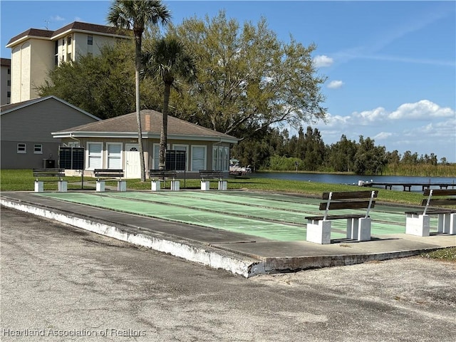 view of property's community with a water view and shuffleboard