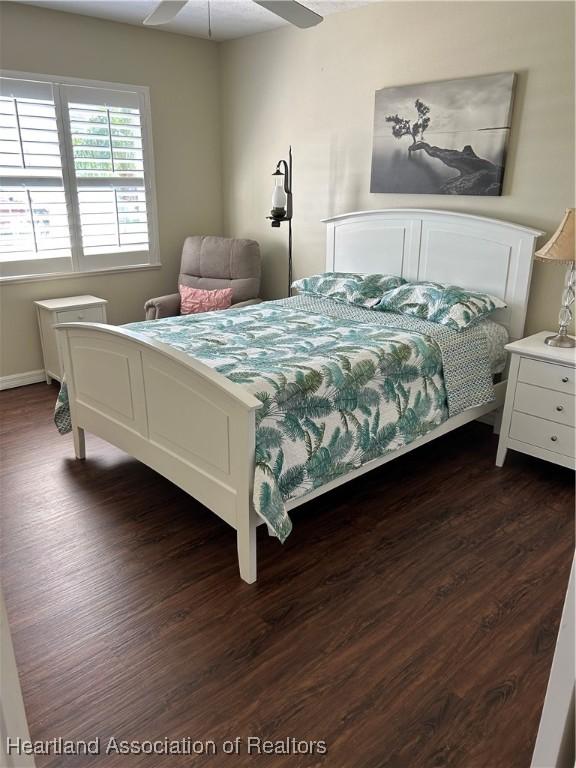 bedroom featuring dark wood-style floors and ceiling fan