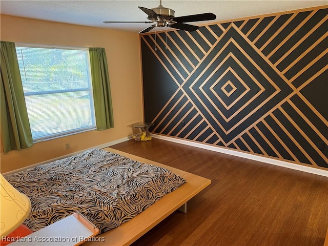 sitting room with wood-type flooring and ceiling fan