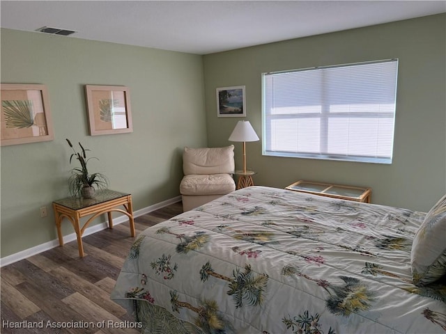 bedroom with dark wood-type flooring