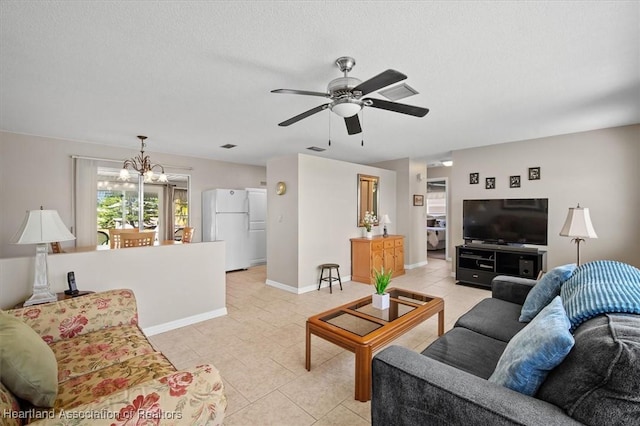 living area featuring light tile patterned flooring, ceiling fan with notable chandelier, a textured ceiling, and baseboards