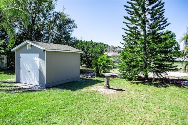 view of yard with an outbuilding and a storage shed