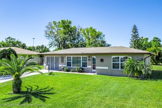 ranch-style house with stucco siding and a front lawn