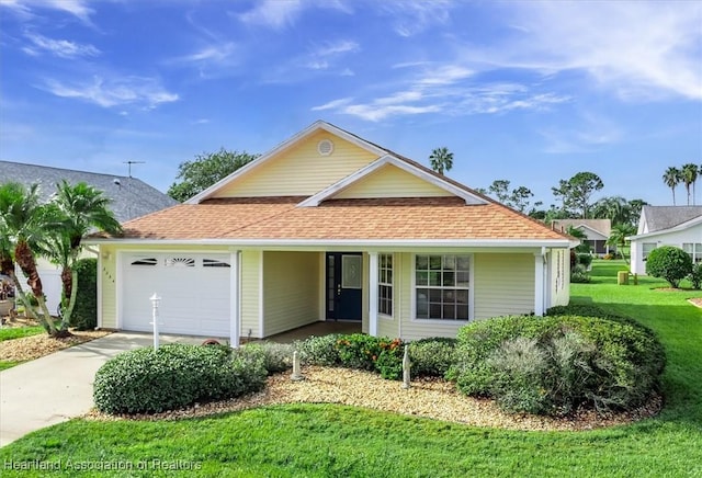 view of front of home featuring a garage and a front lawn