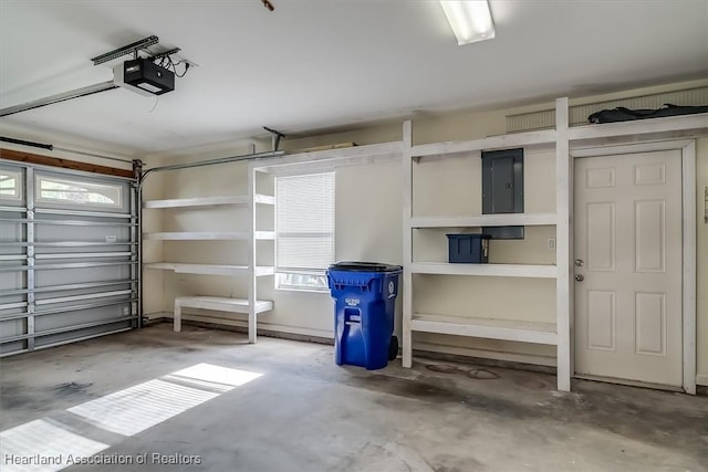 garage featuring a garage door opener and electric panel