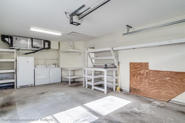 garage featuring independent washer and dryer, a garage door opener, and white refrigerator