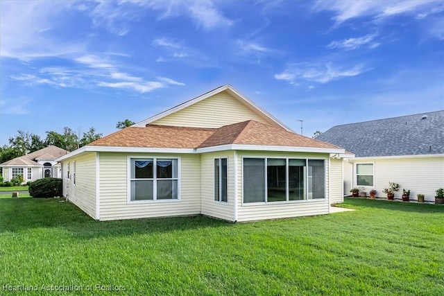 rear view of property featuring a yard