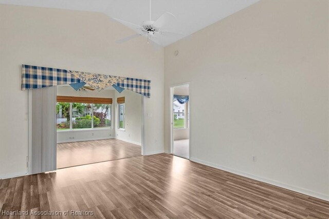 spare room featuring hardwood / wood-style floors, ceiling fan, and lofted ceiling