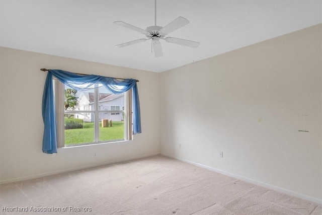 unfurnished room featuring light carpet and ceiling fan