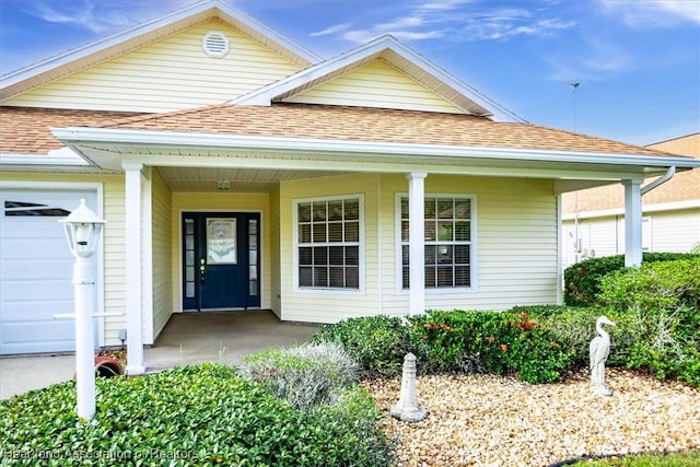 view of front facade featuring a porch and a garage